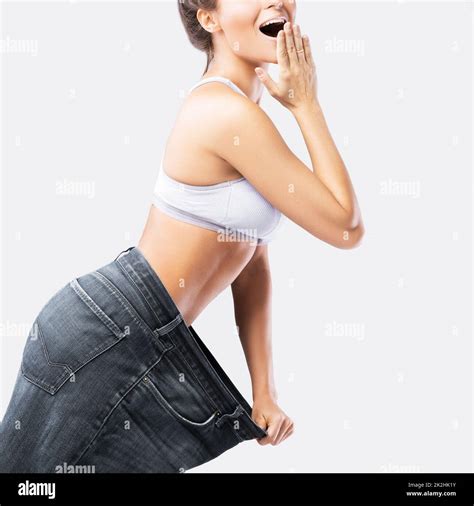 Woman Showing Result After Weight Loss Wearing On Old Jeans Stock Photo