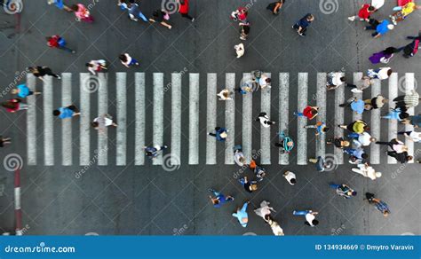 Aerial Blurred Background With Pedestrian Crosswalk And Crowd Of