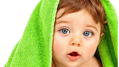 Closeup View Of Grey Eyes Cute Baby Under Green Towel Cloth In White