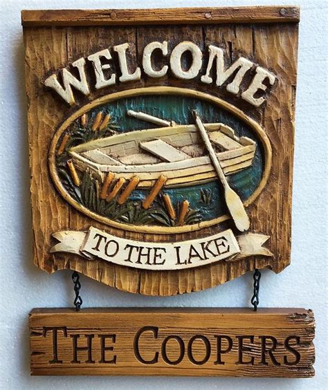 A Wooden Sign That Says Welcome Adam And Blarr With A Boat On It