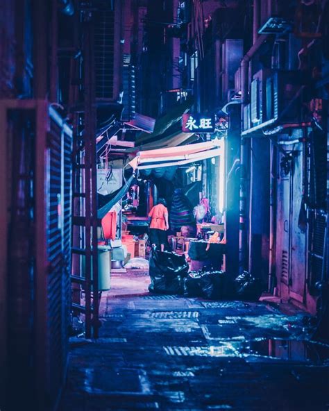 An Alleyway With People Standing In It At Night