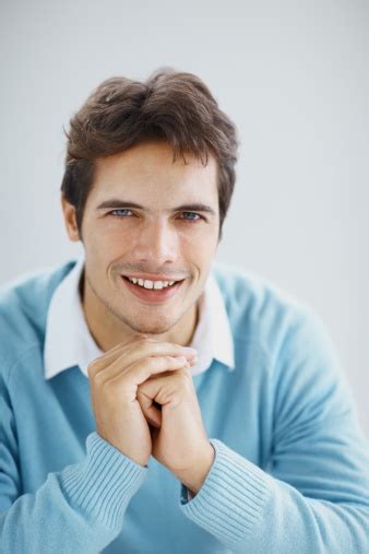 Portrait Of A Smart Young Guy Smiling In Blue Stock Photo Download