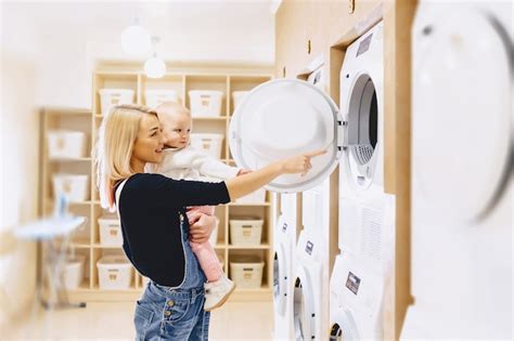 Premium Photo Mom Shows Her Daughter A Washing Machine