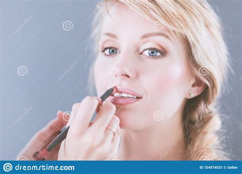 Beautiful Woman Face Hand Of Make Up Master Painting Lips Of Young