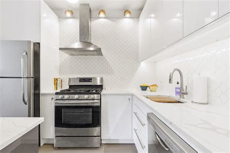 The sleek surface of these cabinets makes them easy to clean and effortless to pair with any design. A White IKEA Kitchen Goes for a Touch of Shine