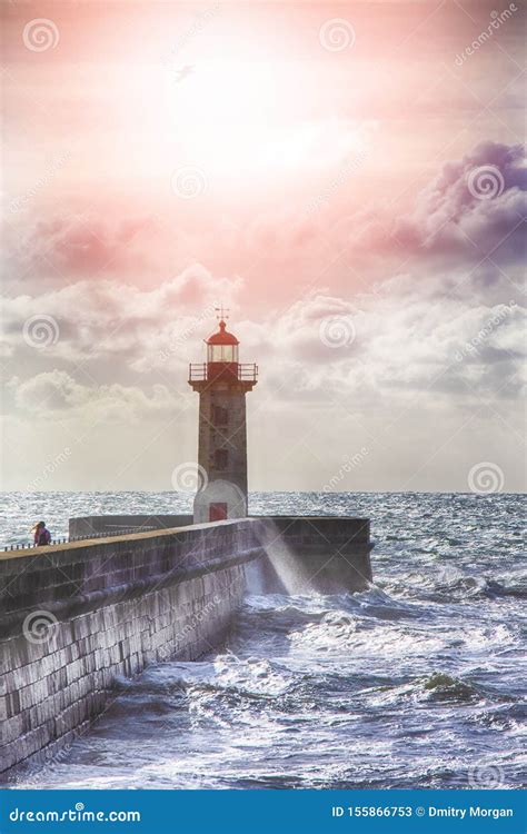 Lonely Lighthouse On The Pier In Porto City In Portugal Against Roaring