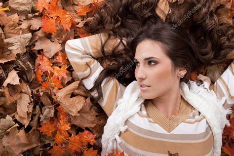 Young Sexy Woman On Autumn Leaves — Stock Photo © Luckybusiness 4267083