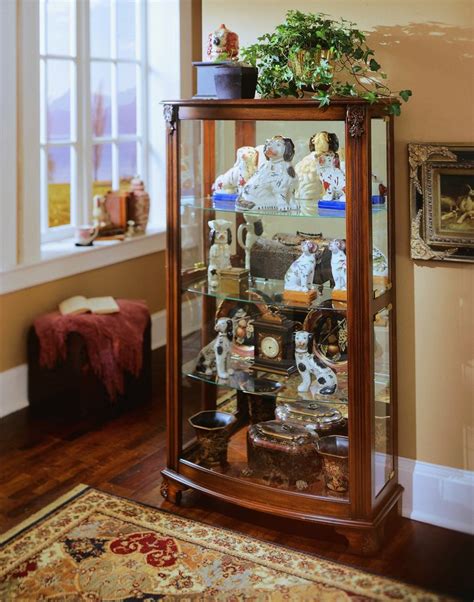 Benzara transitional wooden curio cabinet with two glass doors and four shelves, oak brown. Pulaski Mantel Curio PF-20878 at Homelement.com