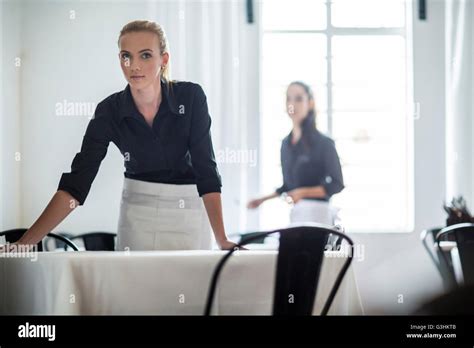 Waitresses Setting Table In Restaurant Stock Photo Alamy
