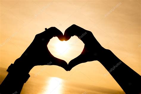 Silhouette Hand Making Heart Shape With Sunset Stock Photo By ©jethita