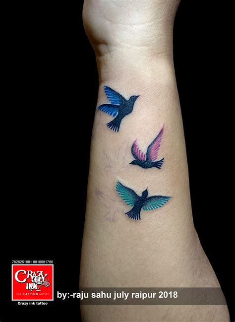 Coloured Flying Bird Tattoo For Girl Tattoo On Wrist Done At Crazyink