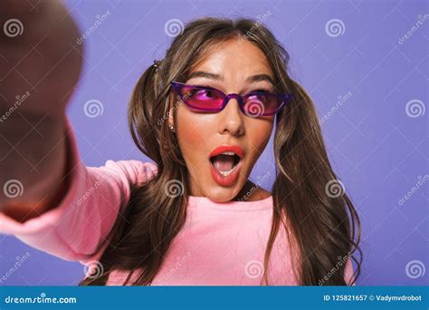 Portrait Of A Shocked Young Girl In Sunglasses Taking A Selfie Stock