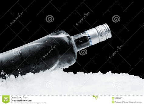 Bottle Of Vodka With Glasses Standing On Ice On Black Background Stock