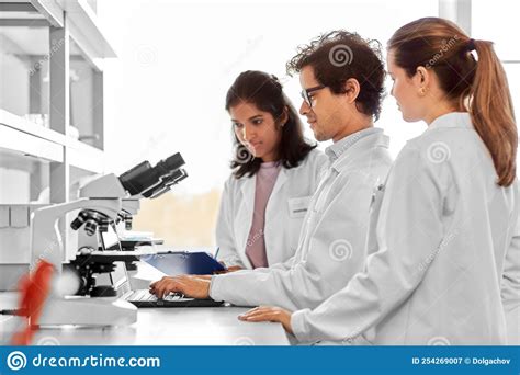Scientists With Microscopes Working In Laboratory Stock Image Image