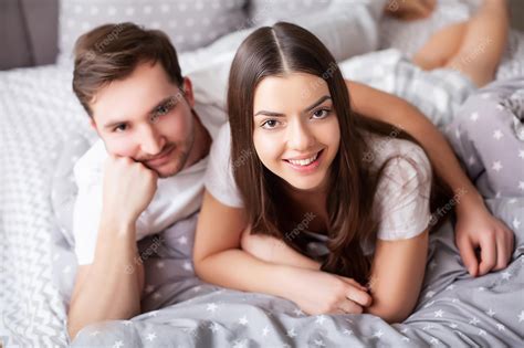 Premium Photo Happy Sensual Young Couple Lying In Bed Together