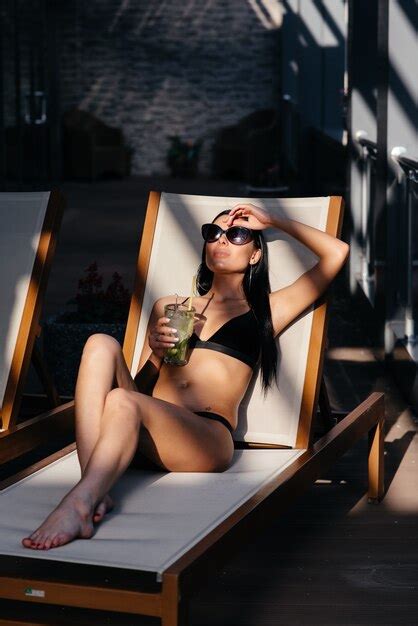 premium photo beautiful woman with glamour make up in stylish black swimwear drink glass