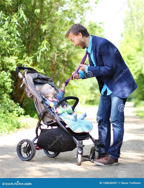 Infant In A Pram Holds His Father By The Tie Stock Image Image Of