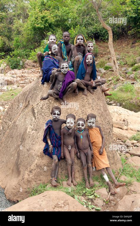 Suri Surma Kids With Painted Faces On A Rock Ethiopia Stock Photo