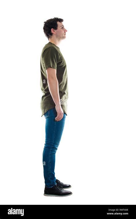 Full Length Side View Of Casual Young Man Standing Relaxed Looking