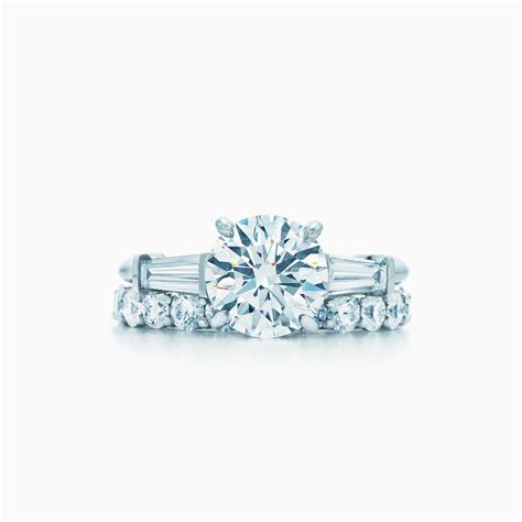In 1886, tiffany introduced the engagement ring as we know it today. Tiffany Three Stone engagement ring with baguette side stones in platinum. | Tiffany & Co.