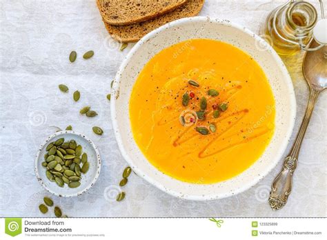 Pumpkin And Carrot Puree Soup With Seeds Pink Pepper And Olive Oil