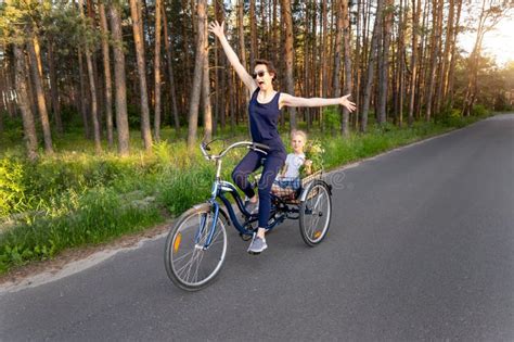 Young Adult Caucasian Mom Enjoy Having Leisure Fun Riding Bicycle With Cute Adorable Blond