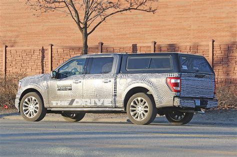 It puts the electric motor on a shortened driveshaft and the battery charging is made by a socket placed on the rear bumper, not exactly a safe area for it to be. New 2021 Ford F-150 Hybrid Spy Shots: The Half-Ton of the ...