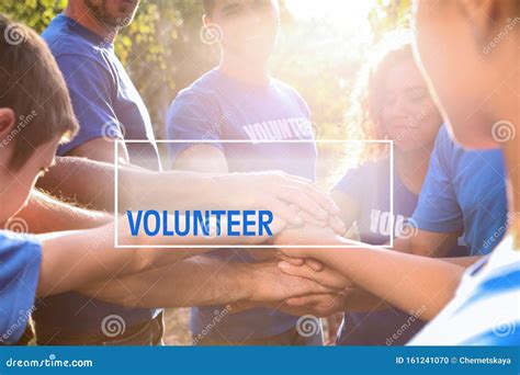Group Of Volunteers Joining Hands Together Outdoors Stock Photo Image