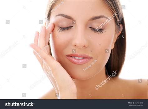 Portrait Of A Beautiful Woman Touching Her Face With Her Eyes Closed
