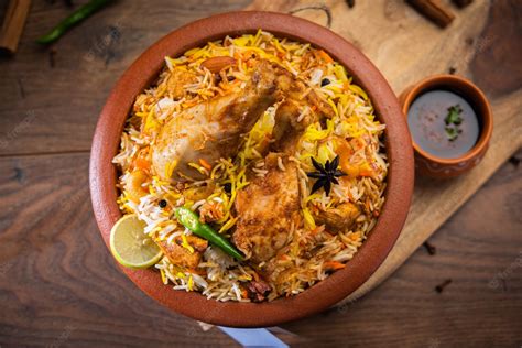 Premium Photo Dum Handi Chicken Biryani Is Prepared In An Earthen Or