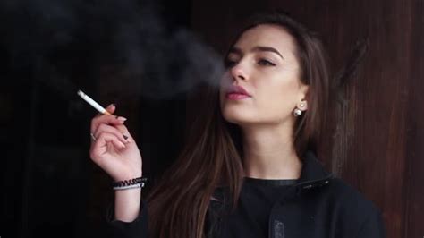 beautiful woman smokes a cigarette in a restaurant slow motion — stock video © krohmalukv