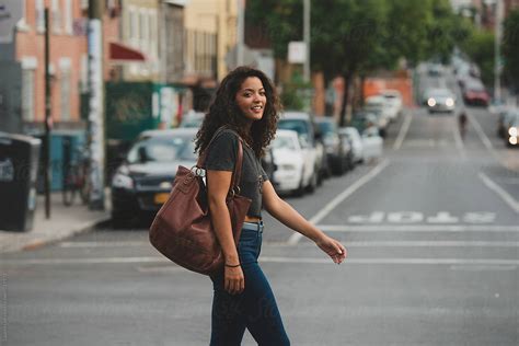 Pretty Young Woman Walking Across The Street By Lauren Lee