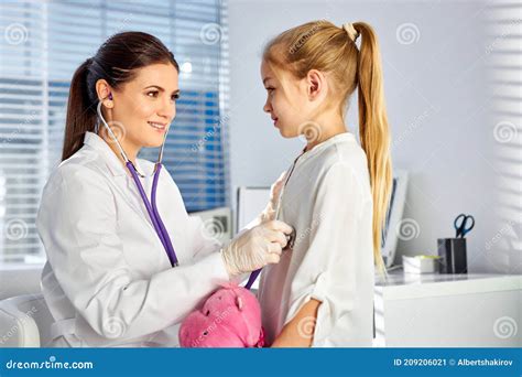 Caucasian Female Doctor Or Pediatrician With Stethoscope Listening To