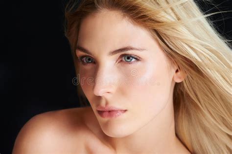 Beauty Up Close And Personal A Blonde Woman Posing In Front Of A