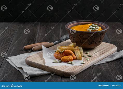 Pumpkin Cream Soup In A Clay Bowl With Snack Fried Croutons Breadbaked