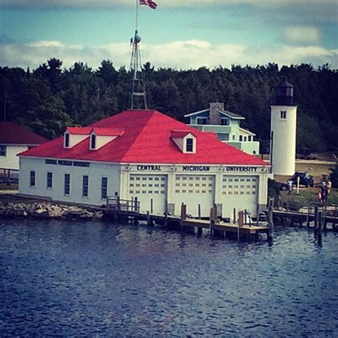 A Large White Building Sitting On Top Of A Body Of Water Next To A