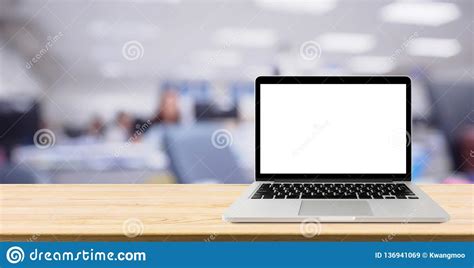 Laptop With Blank Screen On Table With Blur Office Interior Background