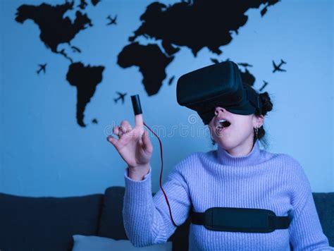 Latin Woman Surprised While Wearing Virtual Reality Set At Home Stock