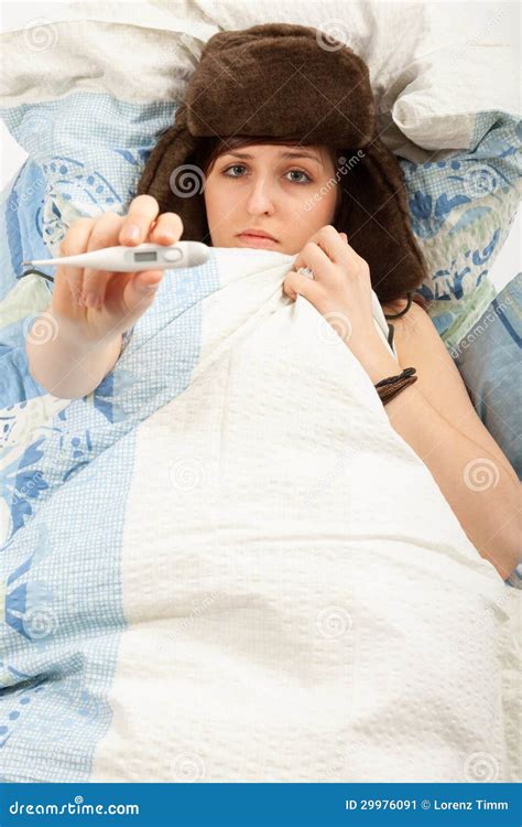 The Girl Is Lying Sick In Bed And Taking Her Temperature Stock Image
