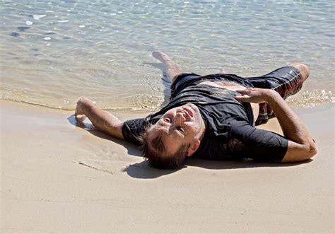 Exhausted Man Lying On The Beach Stock Photo Image Of Lost Lonely