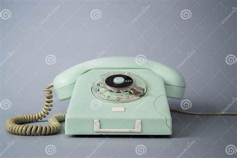 Old Blue Rotary Telephone With Twisted Cord On Gray Background Retro
