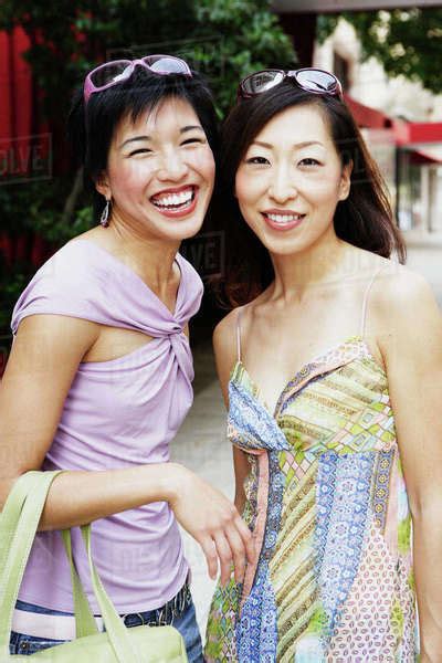 Two Women Posing Outdoors Stock Photo Dissolve