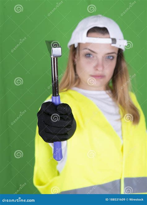 female holding a hammer in a reflective security vest stock image image of green occupation
