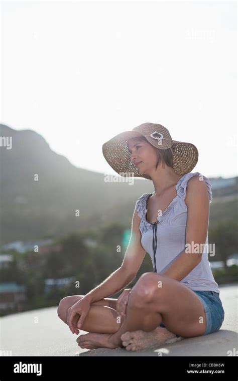 Woman Sitting Cross Legged On Beach Stock Photo Alamy