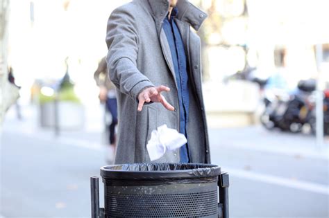 Throw Rubbish In The Bin Throwing Away Garbage In Public Stock