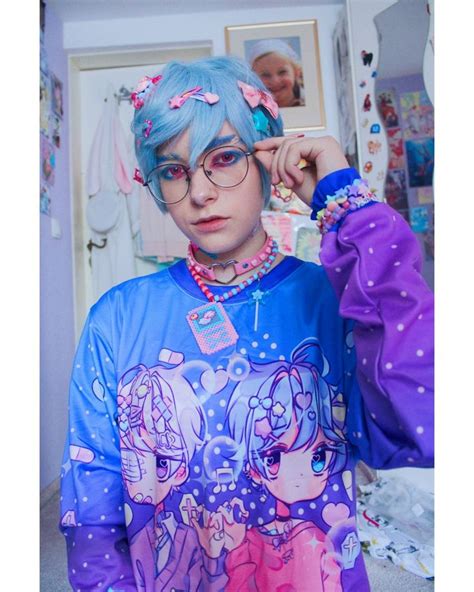 A Woman With Blue Hair Wearing Glasses And A Shirt That Has Cartoon Characters On It
