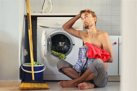Sad Puzzled Look Man Loads The Laundry Into The Washing Machine Male
