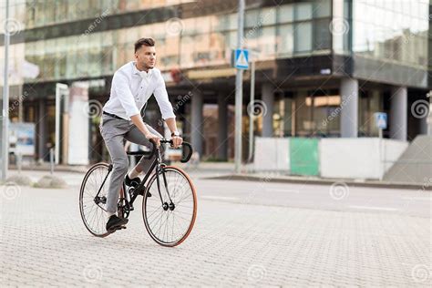 man with headphones riding bicycle on city street stock image image of biking metrosexual