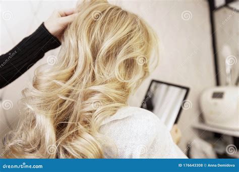 Blonde Girl In A Beauty Salon Doing A Hairstyle Close Up Stock Photo
