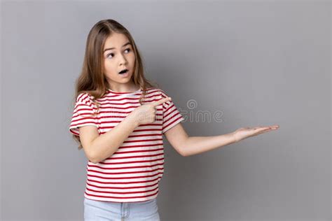 Surprised Little Girl Pointing At Copy Space On Her Palm Empty Place